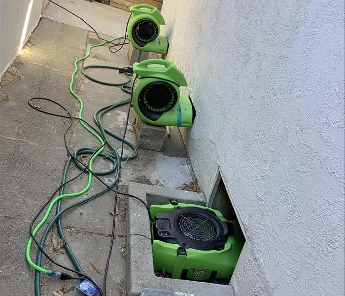 Air Movers drying a crawl space 