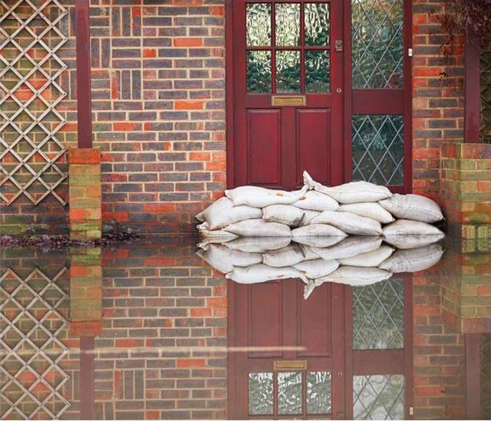 Sandbags At Front Door Of Flooded House